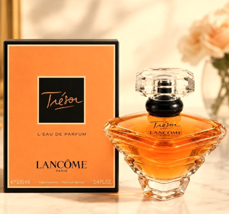 Lancôme Trésor Eau de Parfum for Women, 100 ml (3.4 fl oz), featuring an amber-colored perfume bottle and matching orange box.
