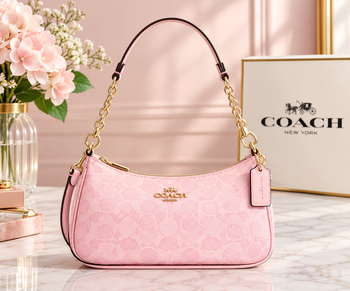 Pink Coach shoulder bag with signature-style pattern, curved silhouette, shoulder strap, and gold-tone hardware.