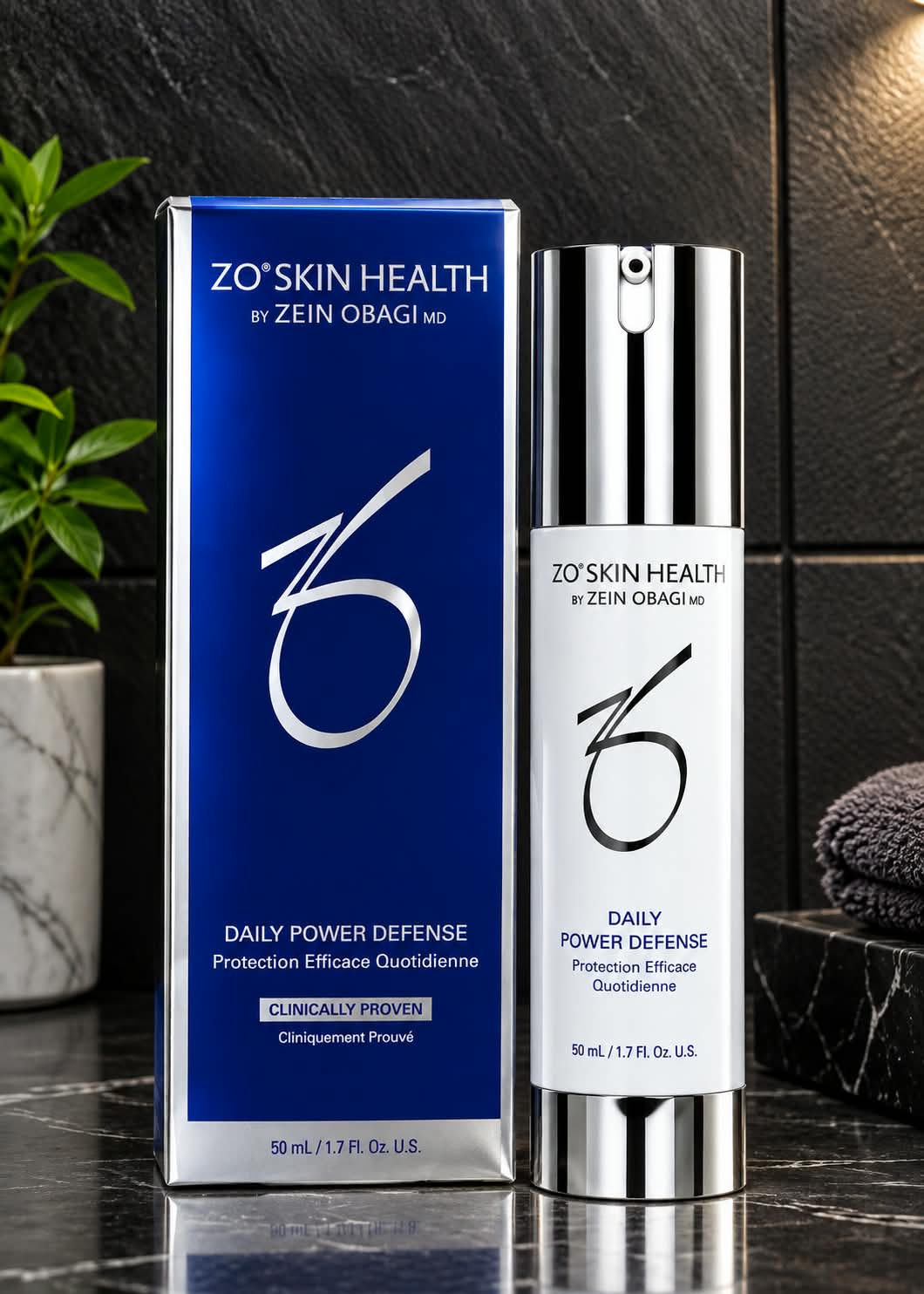 ZO Skin Health Daily Power Defense facial treatment in a white pump bottle with silver accents and a matching blue-and-silver box, 50ml / 1.7 fl oz.